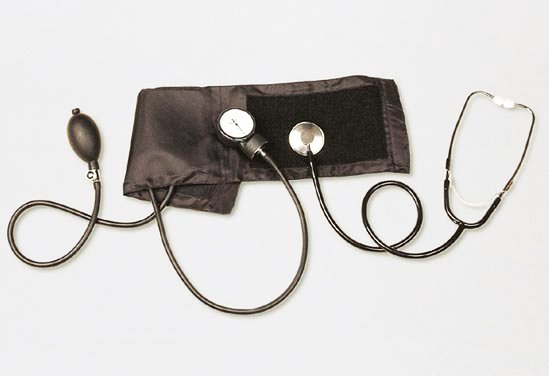Manual blood pressure cuff with gauge and stethoscope on a white background